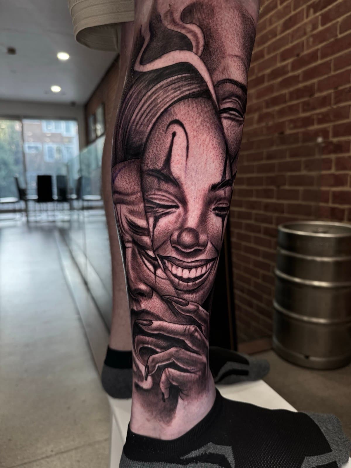 Surreal overlapping portrait faces leg tattoo by Tobias Meredith in Melbourne