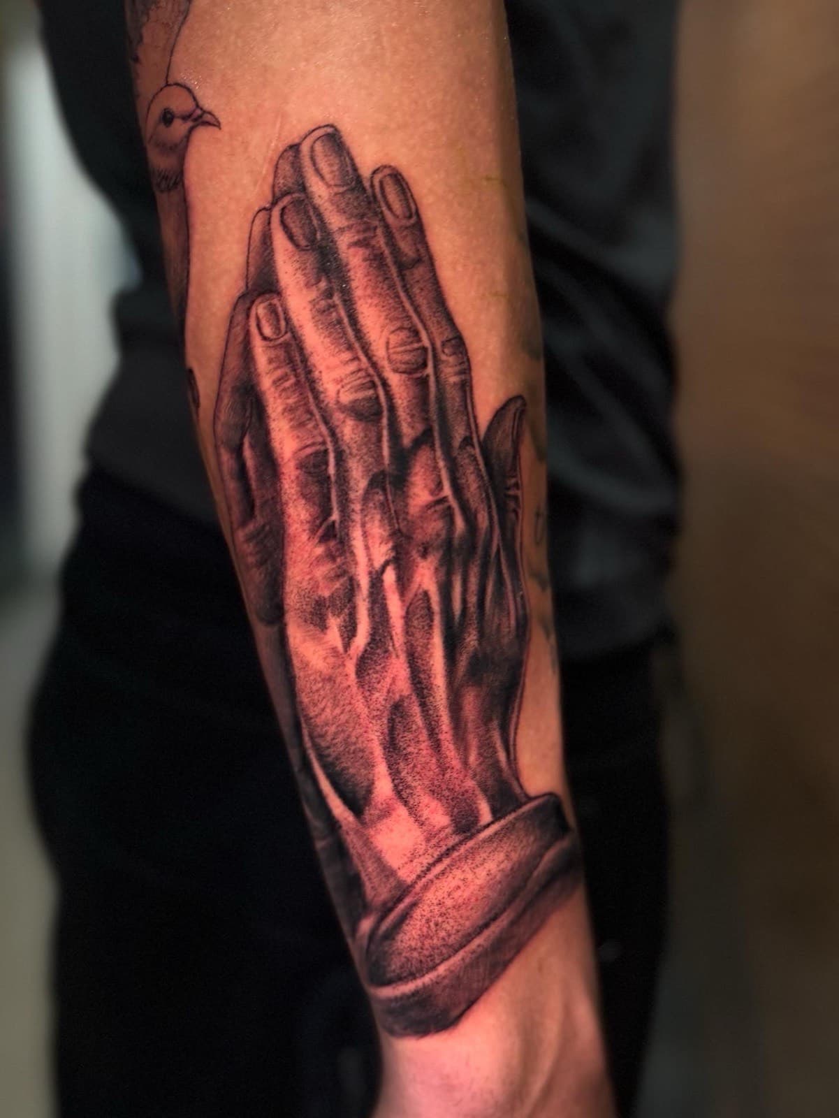 Realistic praying hands forearm tattoo by Tobias Meredith in Melbourne