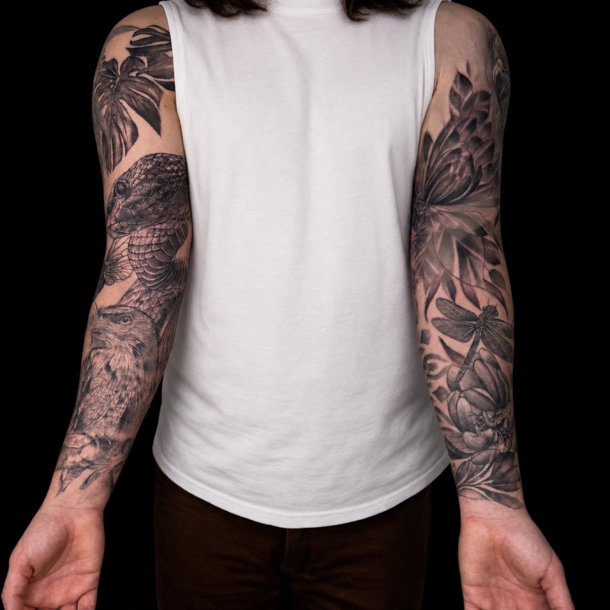 Nature-inspired black and grey sleeve tattoos